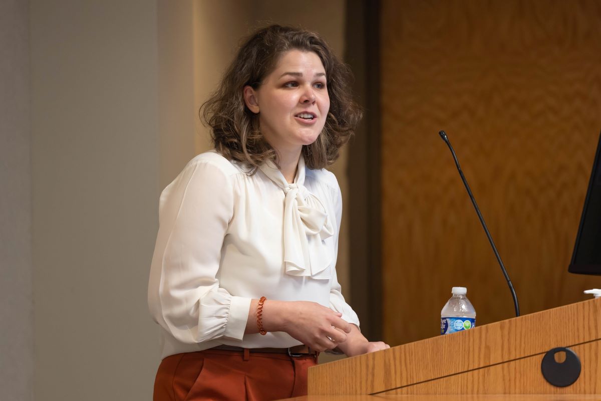 Female presenter standing at the podium at the 2023 SOPH Research Day